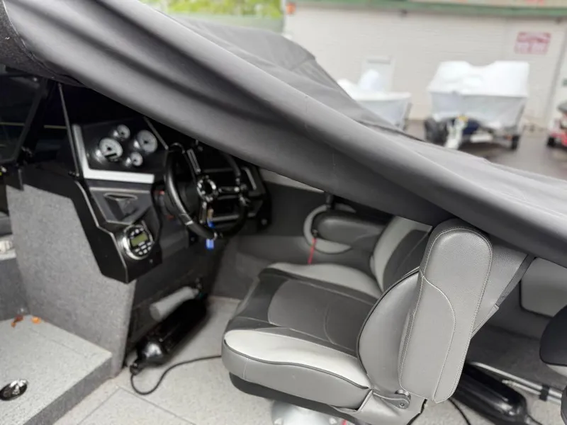 Slide: The Image of Interior of a 2021 Lund 1975 Tyee boat with covered dashboard and seating. - 46