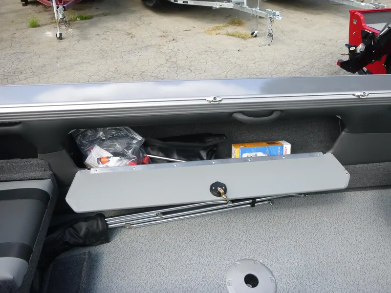 Slide: The Image of Open storage compartment in 2021 Lund 1975 Tyee boat, showing various items inside. - 5