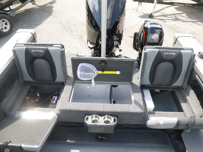 Slide: The Image of Interior of a 2021 Lund 1975 Tyee boat with seating and storage compartments. - 6