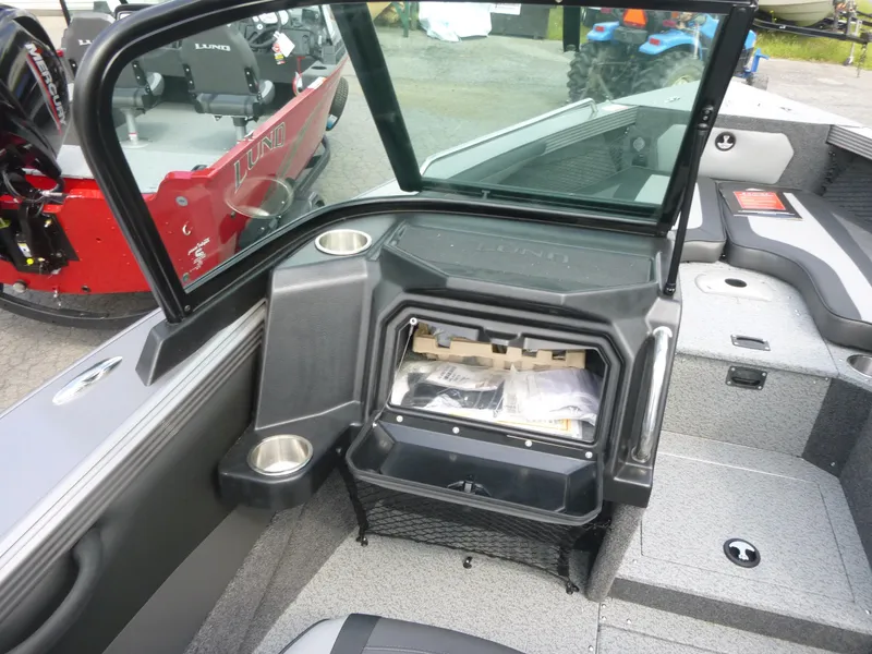 Slide: The Image of Interior of a 2021 Lund 1975 Tyee boat showing storage compartment and seating area. - 7