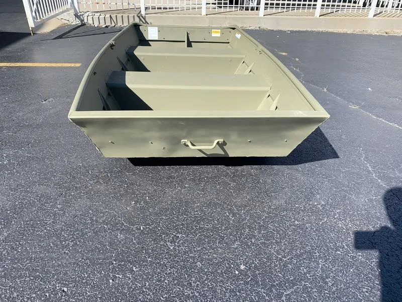 Slide: The Image of 2024 Lowe L1040 Jon boat on pavement, showcasing its sturdy design. - 8