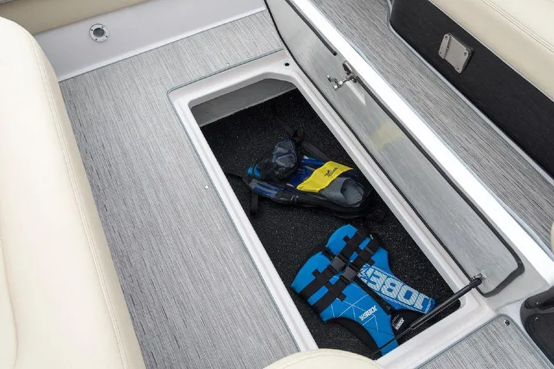 Slide: The Image of 2023 Regal 2800 Bowrider storage compartment with life jacket and snorkeling gear. - 13