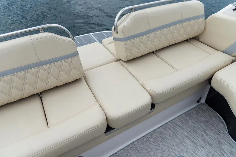 Slide: The Image of 2023 Regal 2800 Bowrider boat with luxurious beige seating on water. - 15