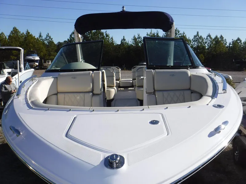 Slide: The Image of 2023 Regal 2800 Bowrider boat with open seating, white interior, and sleek design. - 3
