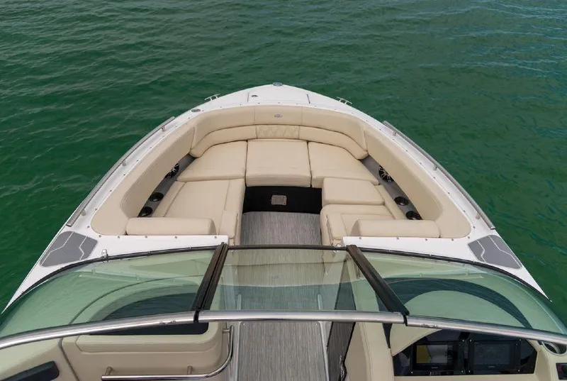 Slide: The Image of 2023 Regal 2800 Bowrider boat with spacious seating on calm green water. - 5