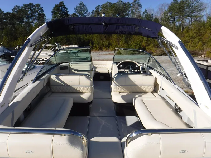 Slide: The Image of 2023 Regal 2800 Bowrider boat with spacious seating and sleek design, docked outdoors. - 7