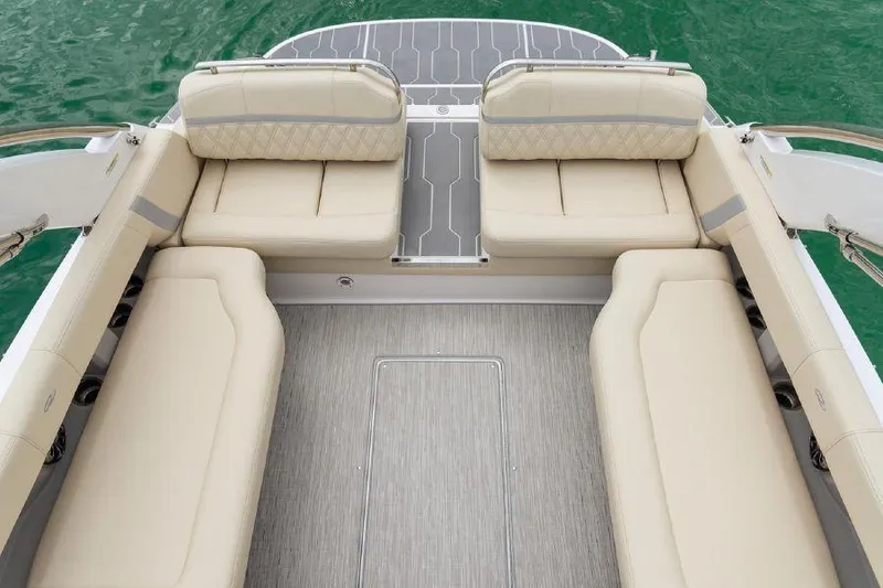 Slide: The Image of 2023 Regal 2800 Bowrider interior with beige seating and gray flooring on water. - 8