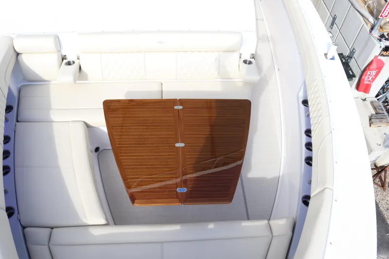 Slide: The Image of 2023 Regal 38 SAV boat interior with white seating and wooden table. - 10