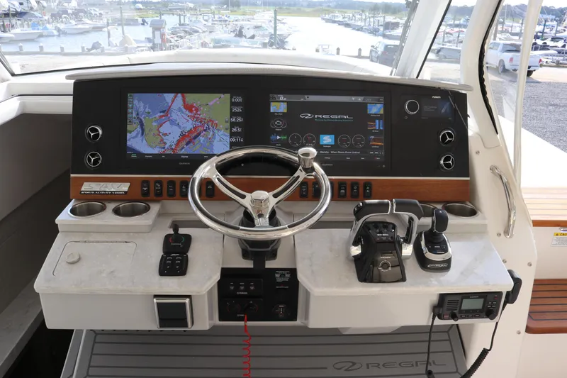 Slide: The Image of 2023 Regal 38 SAV boat dashboard with navigation screens and controls. - 15