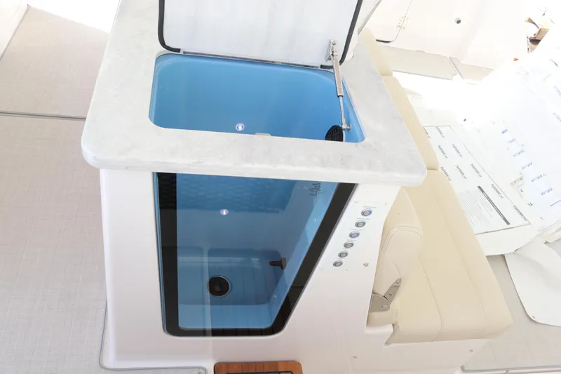 Slide: The Image of 2023 Regal 38 SAV boat interior with open storage compartment and seating. - 19