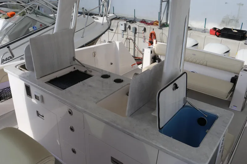 Slide: The Image of 2023 Regal 38 SAV boat interior with kitchenette and seating area. - 20