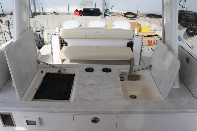 Slide: The Image of 2023 Regal 38 SAV boat interior with kitchenette and seating area. - 21