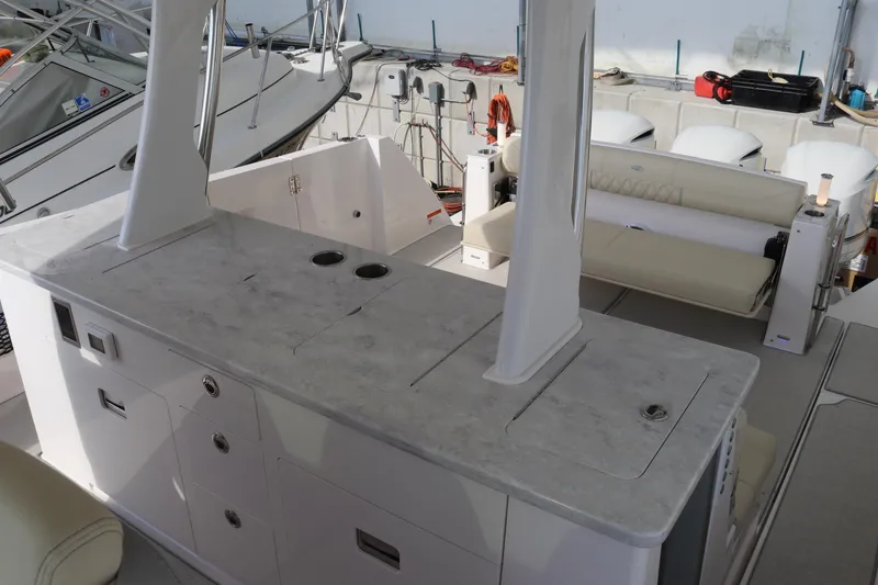 Slide: The Image of 2023 Regal 38 SAV boat interior with sleek countertops and seating area. - 23