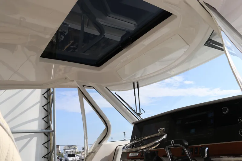 Slide: The Image of 2023 Regal 38 SAV boat interior with steering wheel and sunroof, showcasing modern design. - 28