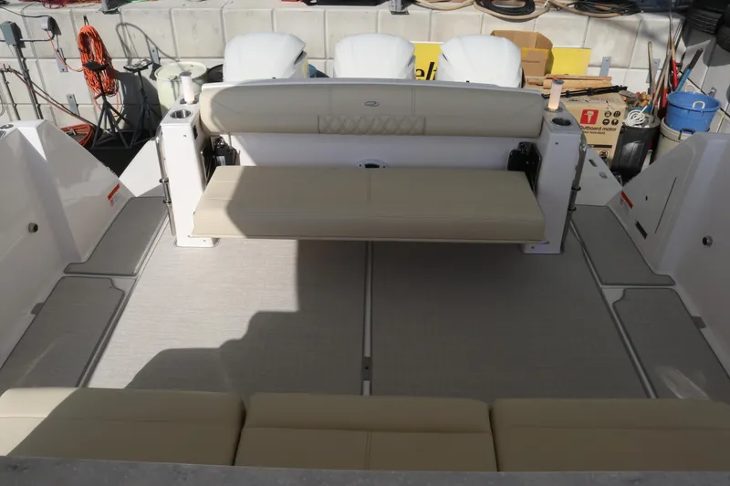 Slide: The Image of 2023 Regal 38 SAV boat interior with beige seating and spacious deck area. - 33