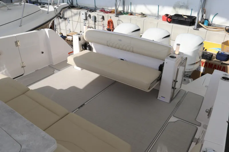 Slide: The Image of 2023 Regal 38 SAV boat interior with beige seating and outboard motors. - 34