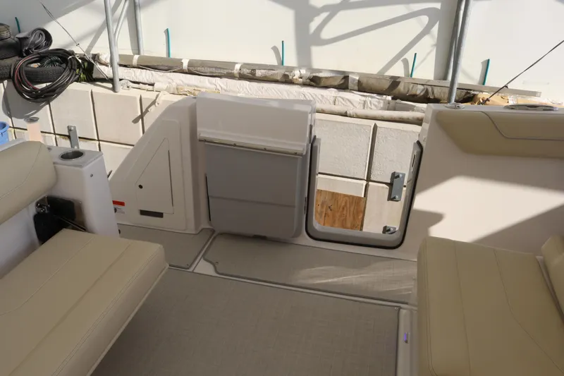 Slide: The Image of 2023 Regal 38 SAV boat interior with beige seating and storage compartments. - 38