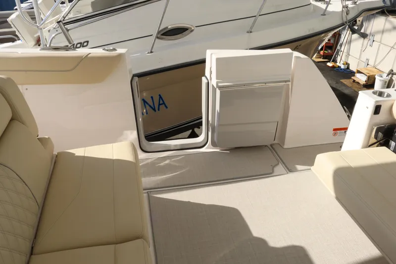 Slide: The Image of 2023 Regal 38 SAV boat interior with beige seating and open deck door. - 39