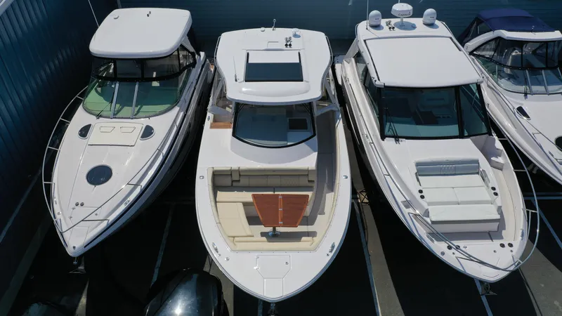 Slide: The Image of Three luxury boats docked, featuring the 2023 Regal 38 SAV model in the center. - 4