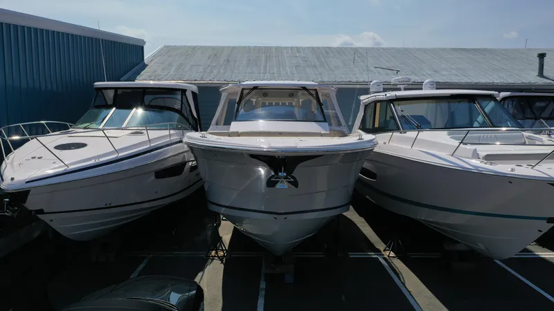 Slide: The Image of 2023 Regal 38 SAV boats docked side by side in a marina. - 41