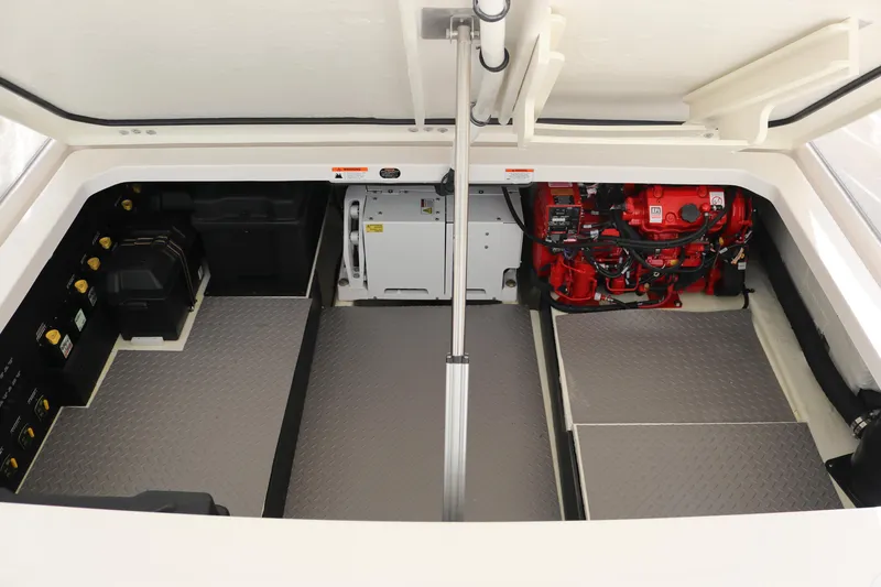 Slide: The Image of Engine compartment of 2023 Regal 38 SAV boat, showcasing mechanical components and storage areas. - 42