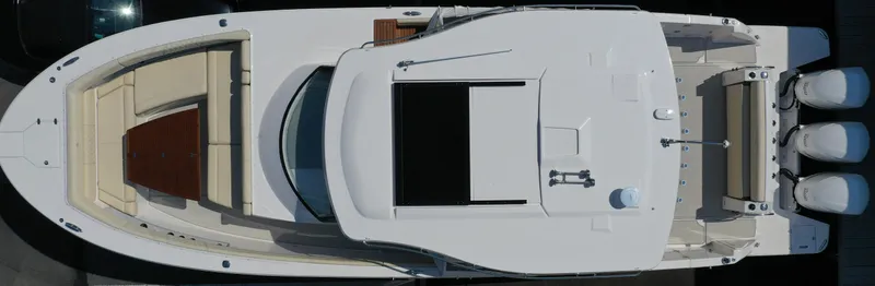 Slide: The Image of 2023 Regal 38 SAV boat, aerial view, showcasing sleek design and triple outboard engines. - 5
