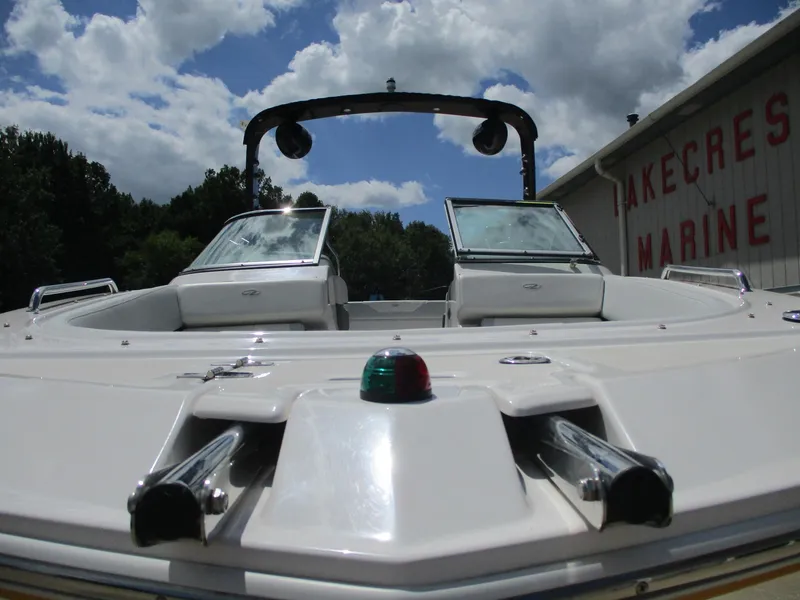 Slide: The Image of 2013 Regal 24 FasDeck RX boat with open bow, under a partly cloudy sky. - 15