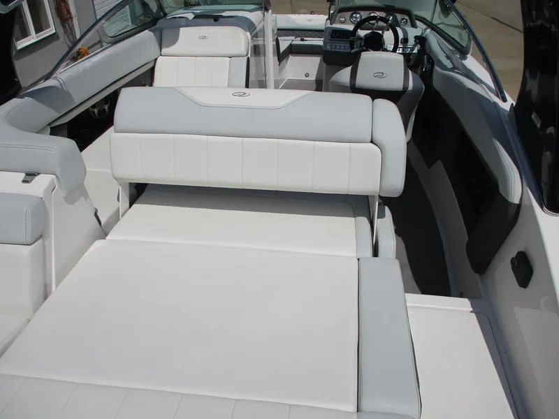 Slide: The Image of 2013 Regal 24 FasDeck RX boat interior with white seating and steering wheel. - 18