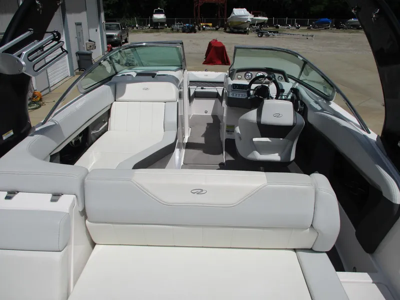 Slide: The Image of 2013 Regal 24 FasDeck RX boat interior with white seating and modern dashboard. - 7