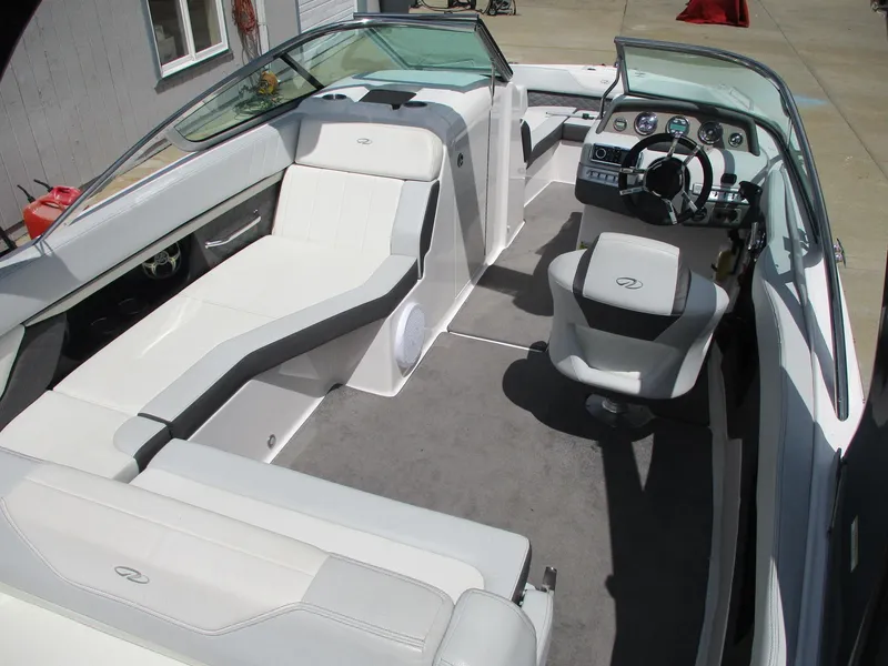 Slide: The Image of 2013 Regal 24 FasDeck RX boat interior with white seating and modern dashboard. - 8