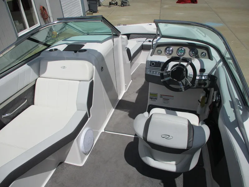 Slide: The Image of 2013 Regal 24 FasDeck RX boat interior with steering wheel and seating. - 9