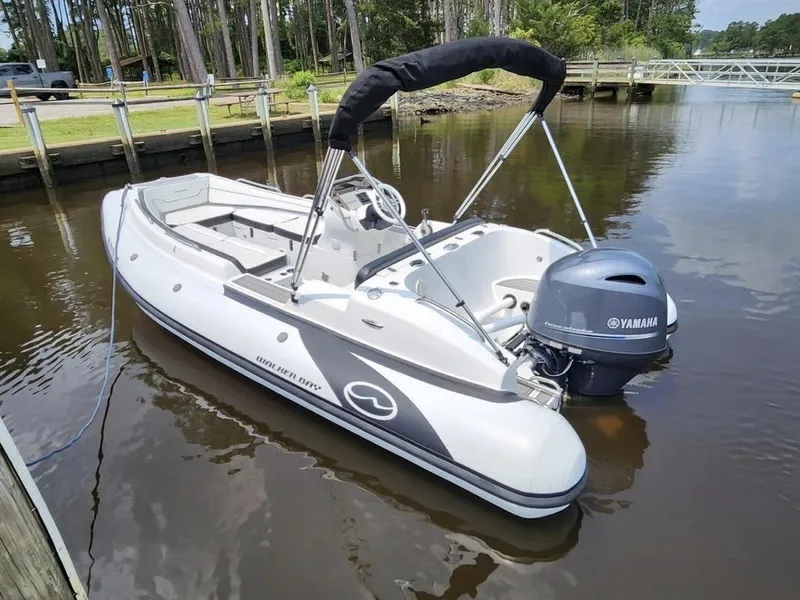 Slide: The Image of 2025 Walker Bay Generation 525 boat docked with Yamaha outboard motor. - 1