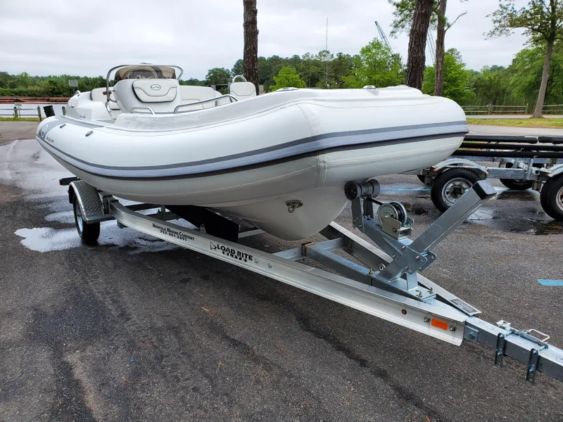 Slide: The Image of 2025 Walker Bay Generation 525 boat on trailer in outdoor setting. - 10