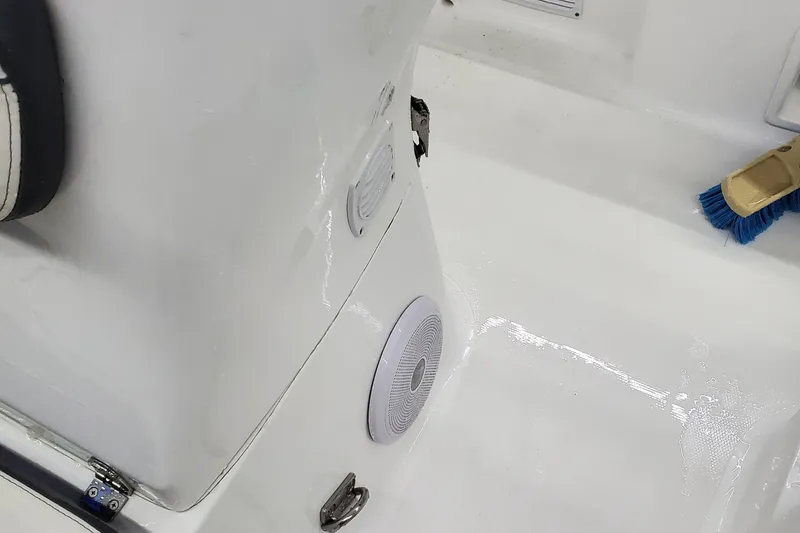 Slide: The Image of Interior view of 2025 Walker Bay Generation 525 boat showing clean white deck and speaker. - 13