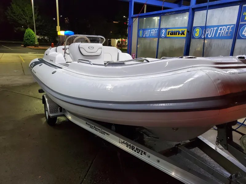 Slide: The Image of 2025 Walker Bay Generation 525 boat on trailer at night. - 15