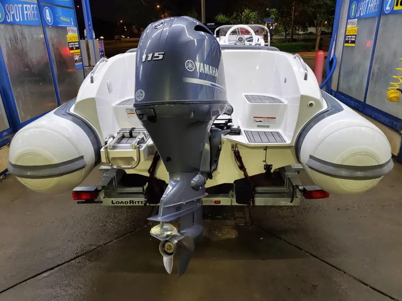 Slide: The Image of Walker Bay Generation 525 boat with Yamaha 115 outboard motor, rear view, 2025 model. - 17