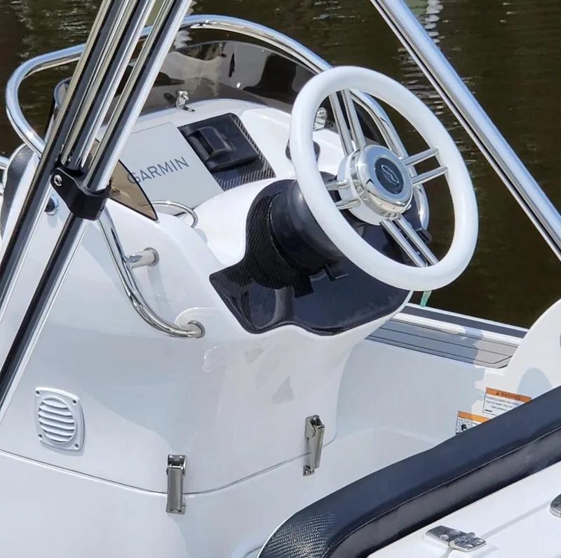 Slide: The Image of 2025 Walker Bay Generation 525 boat steering console with Garmin navigation system. - 2