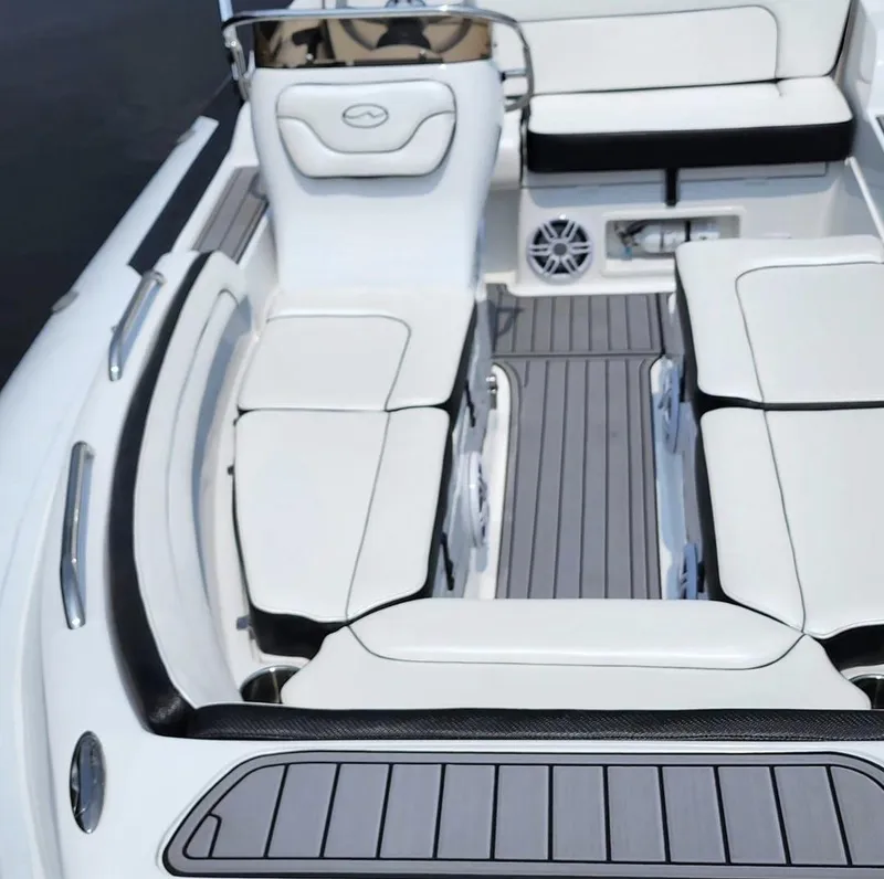 Slide: The Image of 2025 Walker Bay Generation 525 boat interior with white cushioned seating and gray flooring. - 3