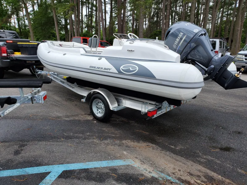 Slide: The Image of 2025 Walker Bay Generation 525 boat on trailer in parking lot. - 8