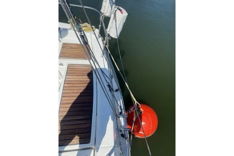 Slide: The Image of Deck view of 2002 Beneteau First 36.7 sailboat with red buoy in water. - 14
