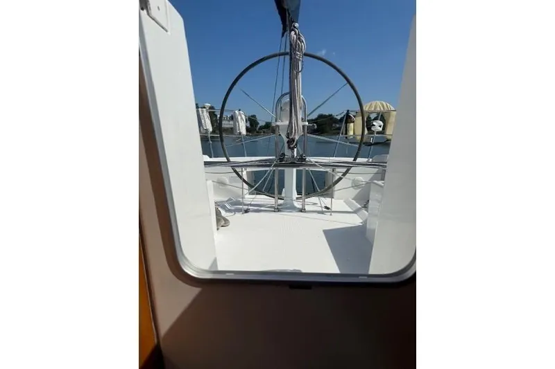 Slide: The Image of Beneteau First 36.7 sailboat cockpit view, showcasing steering wheel and deck, 2002 model. - 18