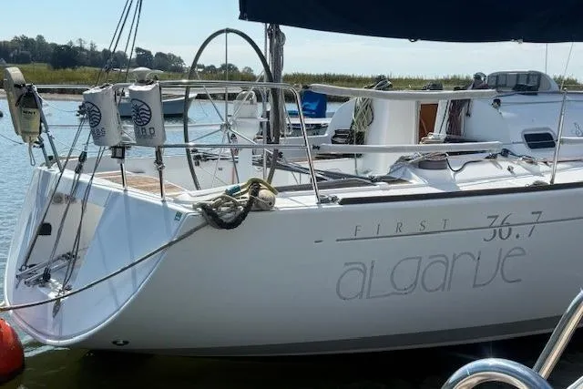 Slide: The Image of Sailboat Beneteau First 36.7, 2002 model, docked in a serene marina setting. - 2