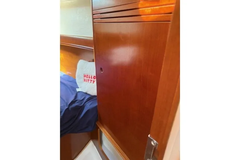 Slide: The Image of Cozy cabin interior of 2002 Beneteau First 36.7 sailboat with wooden paneling and bedding. - 27