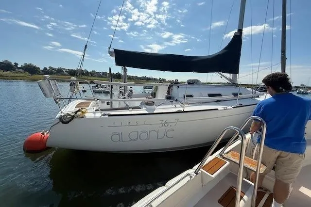 Slide: The Image of Sailboat Beneteau First 36.7, 2002 model, docked with a person boarding. - 3
