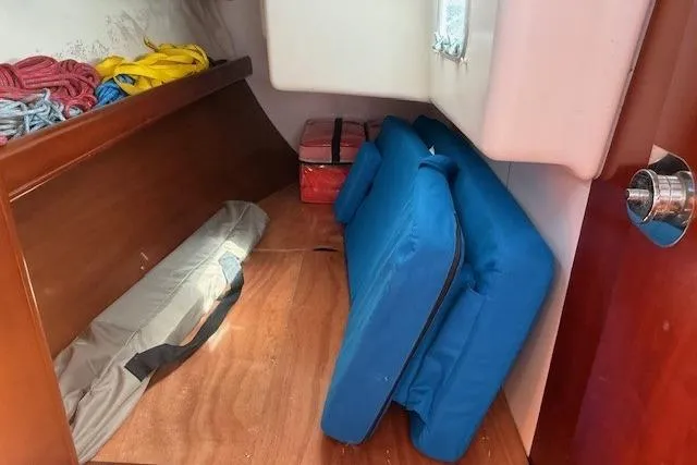 Slide: The Image of Storage area in a 2002 Beneteau First 36.7 sailboat with cushions and ropes. - 30