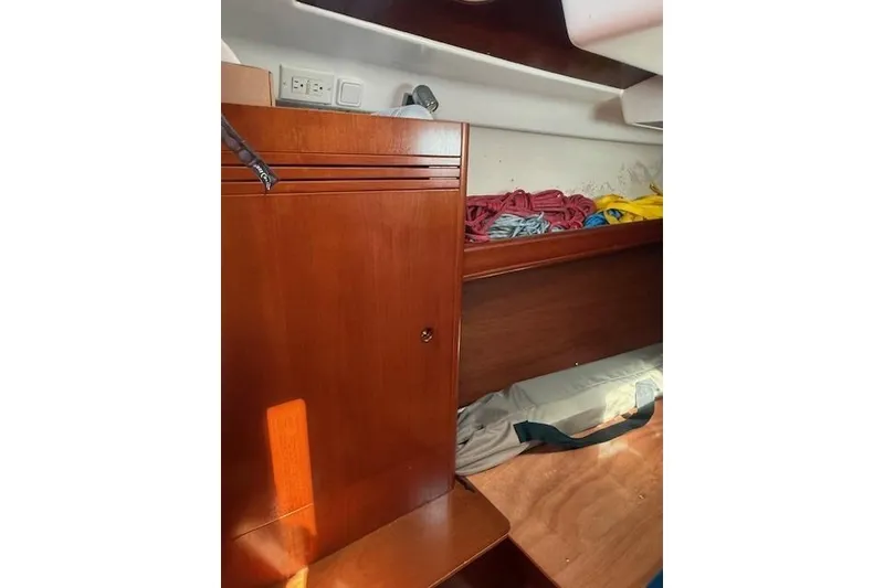 Slide: The Image of Interior of 2002 Beneteau First 36.7 sailboat with wooden cabinetry and storage space. - 31