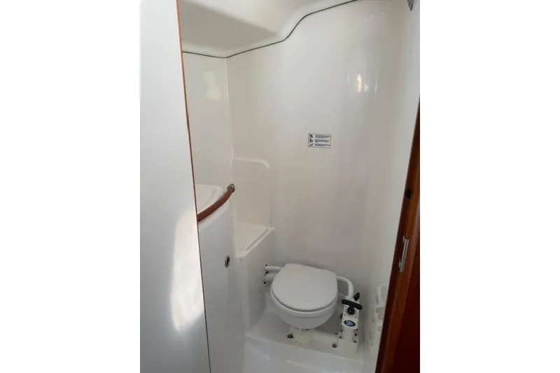 Slide: The Image of Compact bathroom in 2002 Beneteau First 36.7 sailboat, featuring a marine toilet. - 32