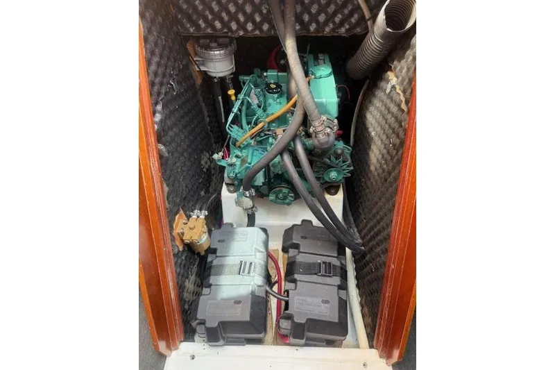 Slide: The Image of Engine compartment of 2002 Beneteau First 36.7 sailboat, featuring a compact marine engine. - 37