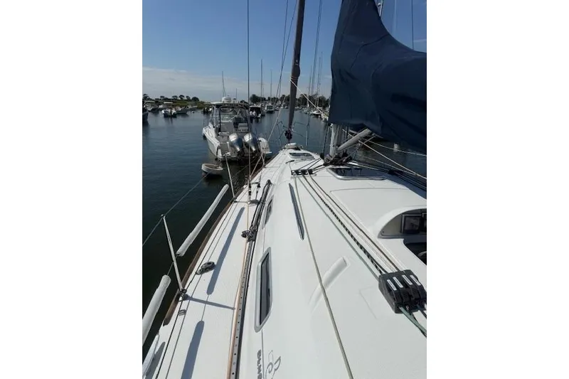 Slide: The Image of 2002 Beneteau First 36.7 sailboat docked in a marina, showcasing deck and rigging. - 4