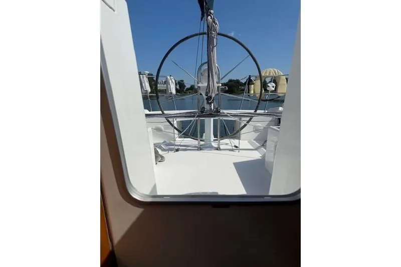 Slide: The Image of 2002 Beneteau First 36.7 sailboat cockpit view with steering wheel, docked on a sunny day. - 42